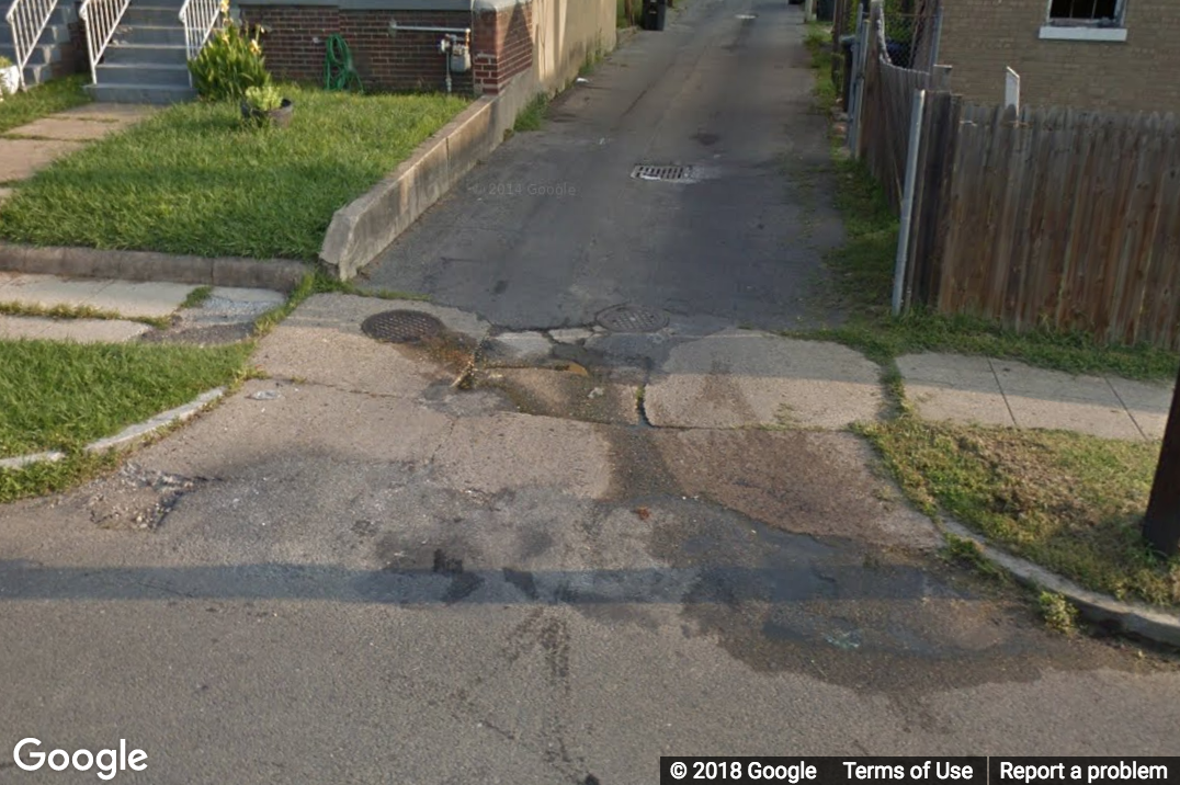 A Street View image of a driveway with many cracks